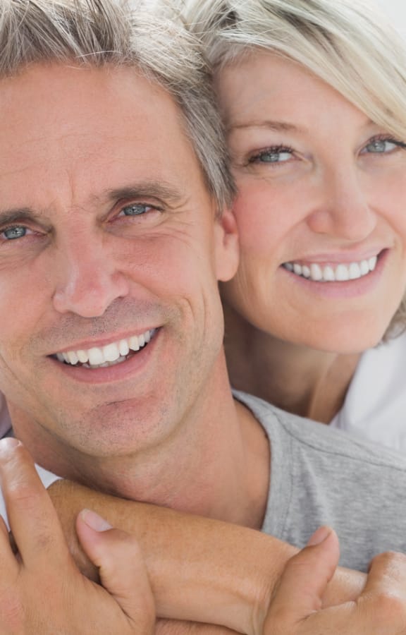 Mature couple holding each other and smiling