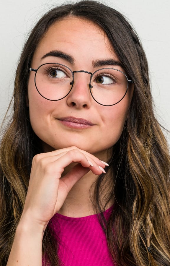 Woman holding her hand below her chin and thinking