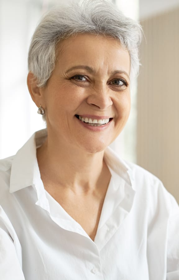 Mature woman sitting at her desk on the computer