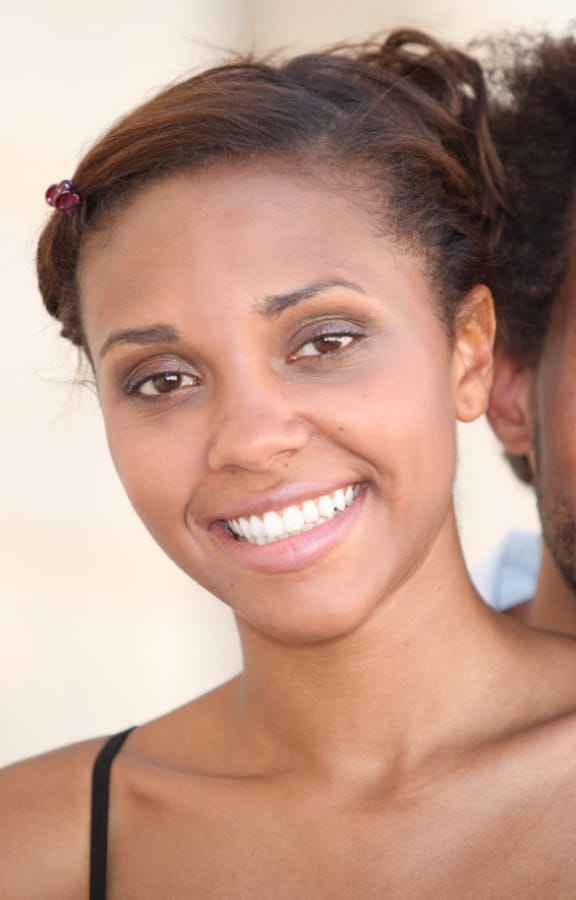 Middle aged couple standing next to each other smiling
