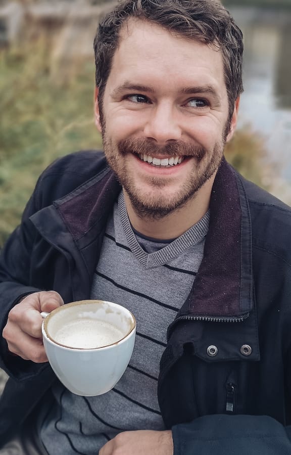 Man sitting down having coffee