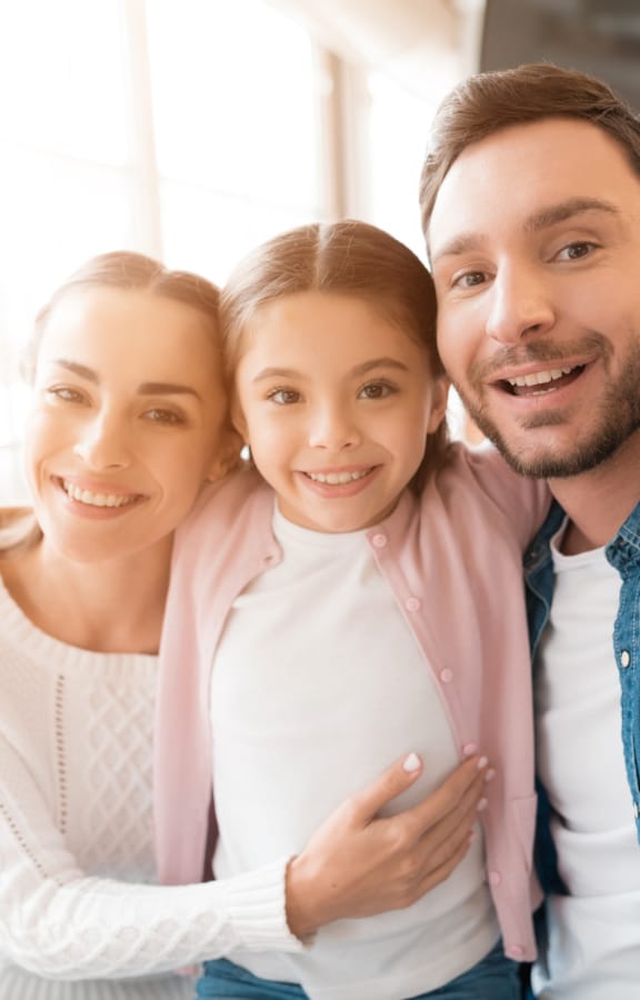 Family of three in their living room taking a selfie