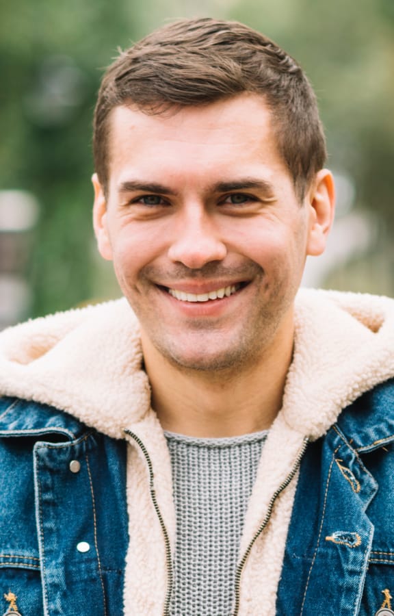Man standing in the park and smiling