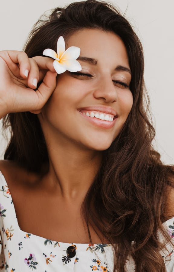 Woman holding a flower in her hair