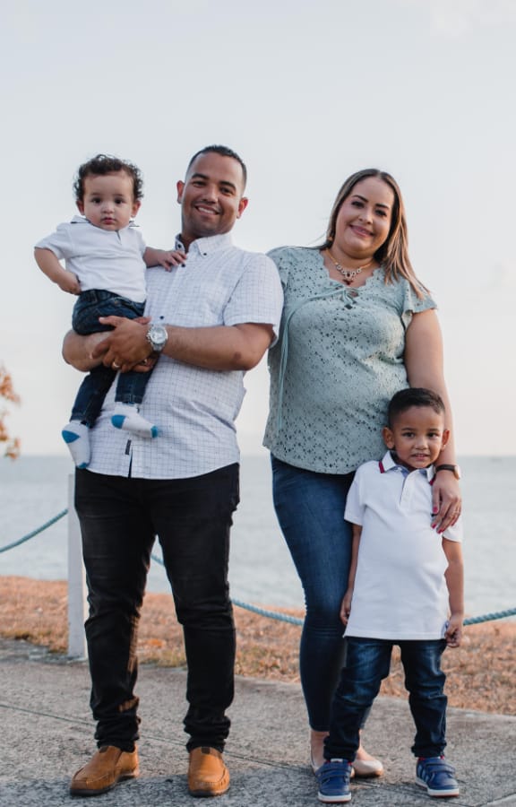 Family of four standing in a field and enjoying the weather
